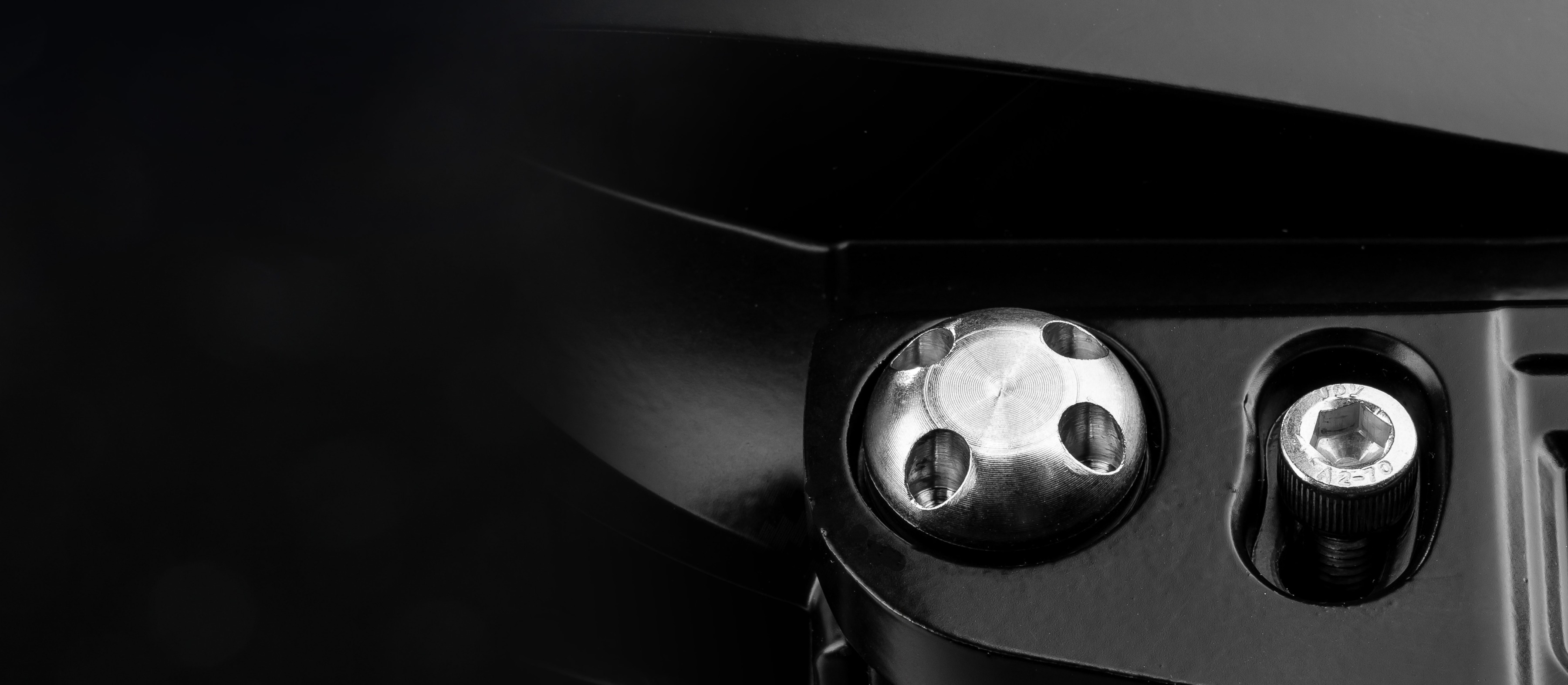 Macro of the anti-theft bolts on an EVO led driving light.