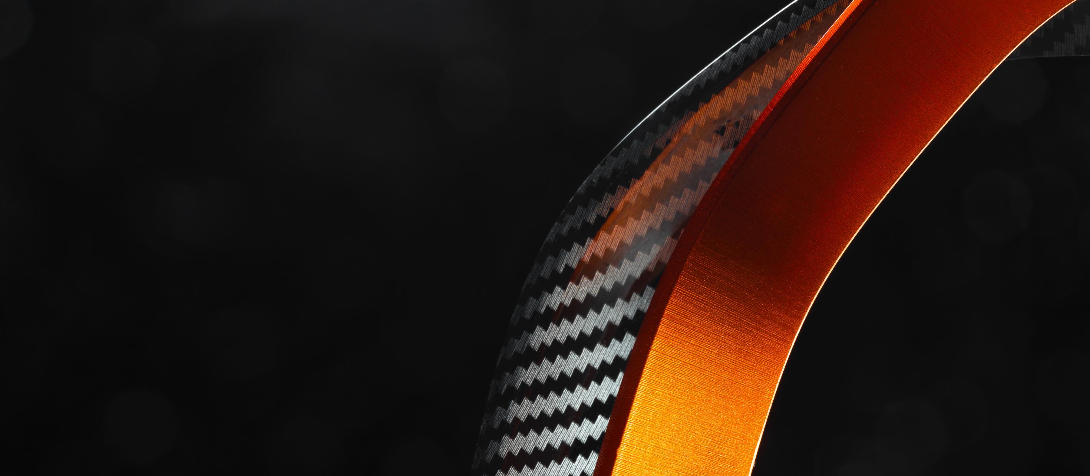 Macro of a carbon fiber ring on an EVO led driving light, on a black background.